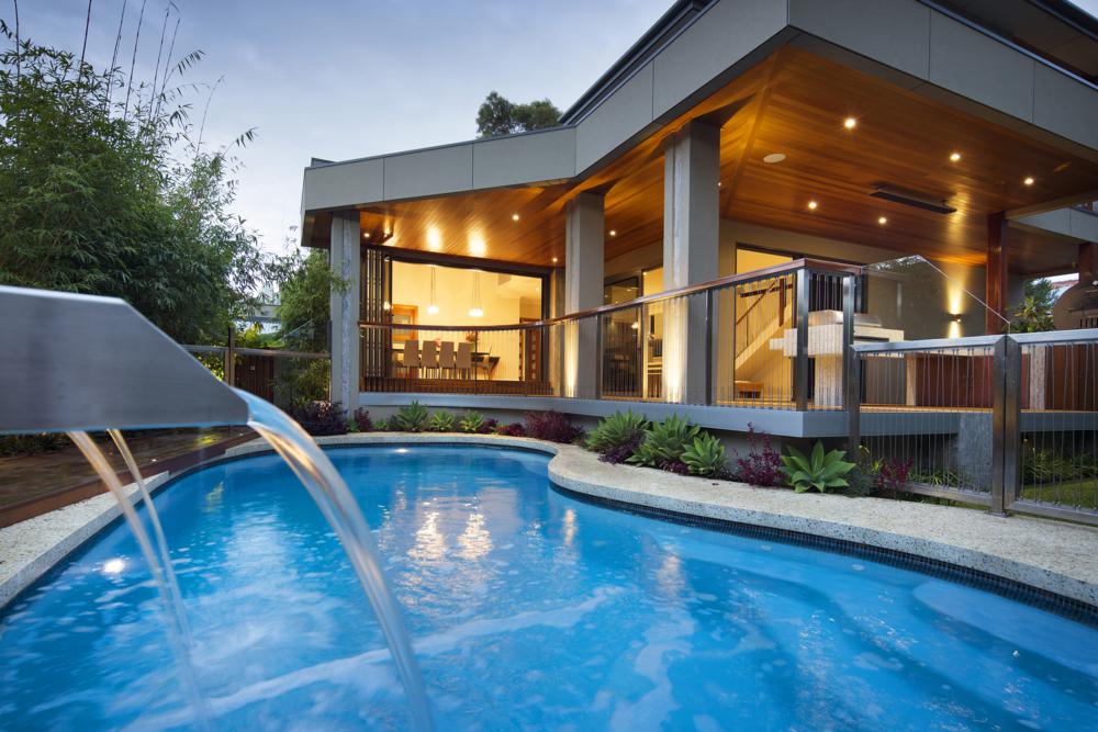 beautiful pool in backyard of luxury custom home