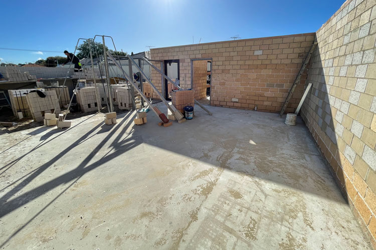 unit development in progress showing concrete slab and partial wall construction