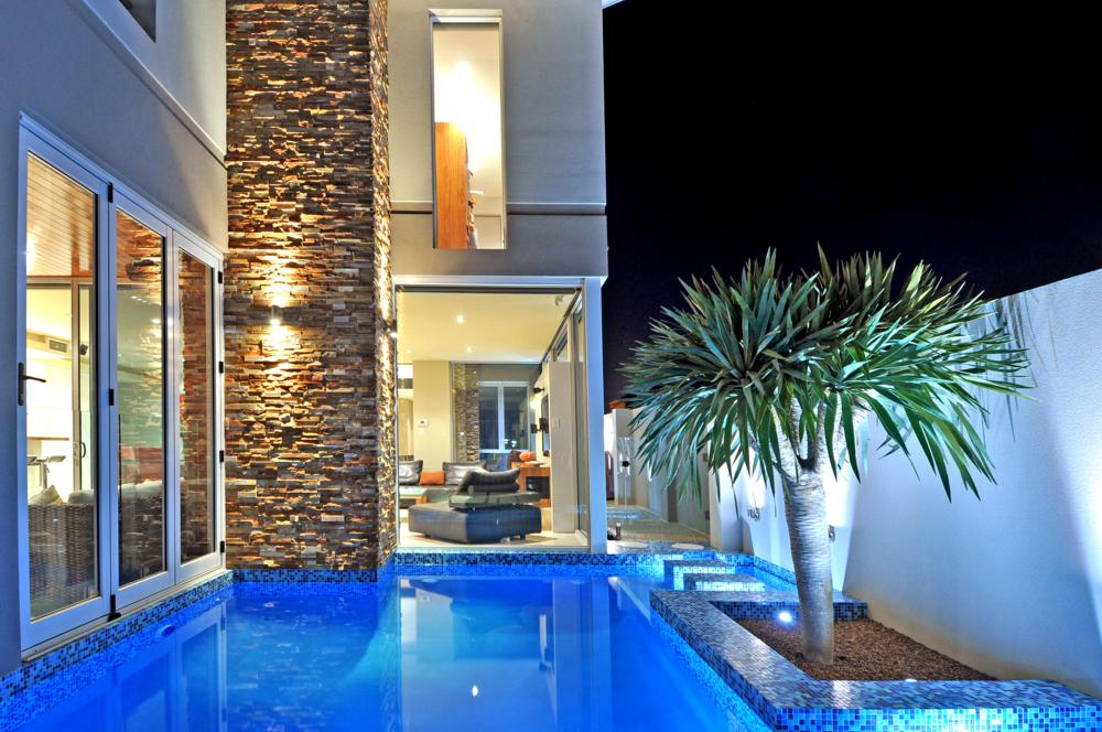 view along side of this boutique home over pool and down to main living area.