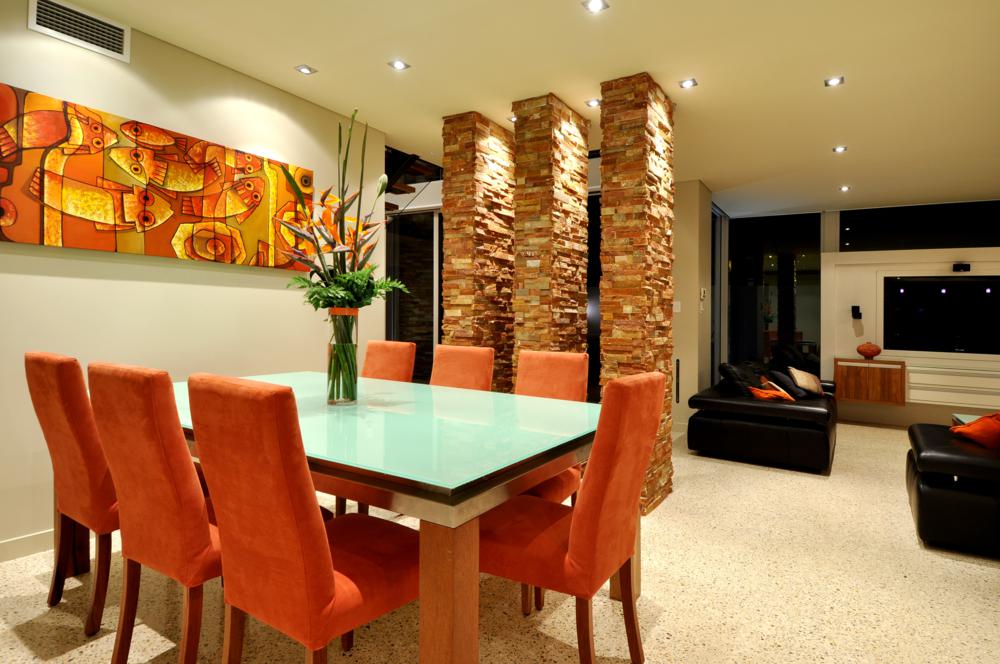 bright dining area next to rough stone columns.