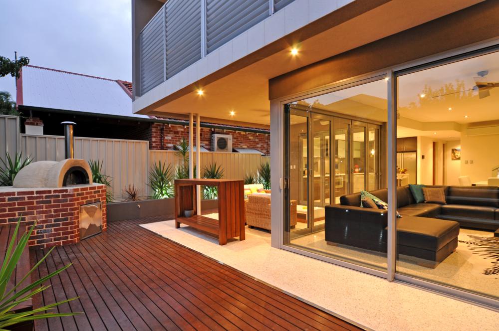 large glass door windows seamlessly integrate the indoors and outdoors of this luxury home.